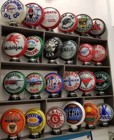 many different types and colors of beer caps on display in a store window or office