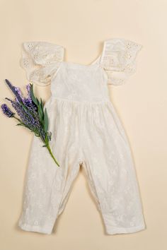 This jumpsuit is the most beautiful and comfortable outfit that will be in your childs wardrobe. Featuring embroidered lightweight material and a bow detail on the back! Fit: true to size Cute Spring Overalls Jumpsuits And Rompers, Cute Spring Overalls And Rompers, Spring Cotton Onesie, Spring Cotton Jumpsuits And Rompers For Playwear, Cotton Jumpsuits And Rompers With Ruffles, Cute Bubble Romper Overall For Spring, Cute White Overalls For Spring, Spring Playwear Jumpsuits And Rompers, Cute Cotton Overalls And Rompers