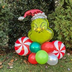 an inflatable dr seuss balloon sitting on top of some candy canes