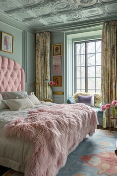 a bed with pink fur on it in a bedroom next to a window and curtains