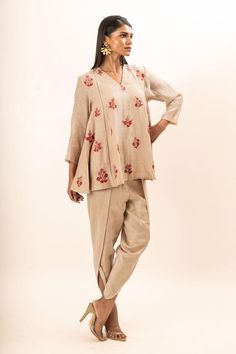 Beige tunic with scattered floral embroidery. Paired with a dhoti pant.
Components: 2
Pattern: Embroidery
Type Of Work: Floral
Neckline: V Neck
Sleeve Type: Three Quarter Sleeves
Fabric: Tunic: Chanderi, Dhoti Pant: Bamber silk, Lining: Mul cotton
Color: Beige
Other Details: 
Attached inner lining
Closure: Elastic
Occasion: Work,Resort - Aza Fashions Slub Silk Sets With Resham Embroidery For Puja, Unstitched Floral Embroidery Blouse For Navratri, Festive Chikankari Embroidered Top For Navratri, Chanderi Pant Set With Floral Embroidery, Chanderi Resham Embroidery Straight Kurta Top, Anarkali Tunic Sets With Chikankari Embroidery, Anarkali Chikankari Embroidery Tunic Set, Straight Kurta Top With Resham Embroidery In Chanderi, Anarkali Blouse With Chikankari Embroidery For Puja