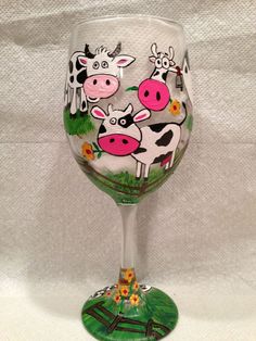 a wine glass painted with farm animals on it