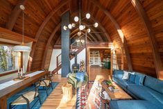 a living room filled with furniture and wooden walls