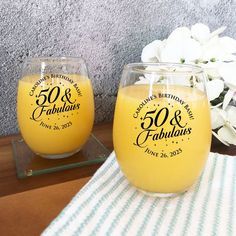 two wine glasses sitting on top of a table