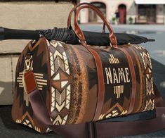 This personalized southwestern Ombre style tribal Indian travel bag is all about style. Our leather western boho duffel bag is made with high-grade waterproof fabric, it's a highly durable means of transferring your essentials wherever you go. With multiple compartments, a resilient carrying handle, and an adjustable shoulder strap, it's the perfect companion for all your adventures. This southwestern aztec tribal Indian design will have everyone asking where you got it, great Christmas or birth Bohemian Brown Leather Duffle Bag, Bohemian Brown Weekender Bag For Weekend Trips, Bohemian Brown Weekender Bag For Overnight Trips, Brown Bohemian Weekender Bag For Overnight Trips, Brown Bohemian Travel Bag With Luggage Sleeve, Bohemian Brown Duffle Bag For Weekend Trips, Bohemian Brown Weekender Bag With Large Capacity, Bohemian Brown Duffle Bag For Travel, Indian Travel