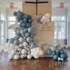 balloons are arranged in the shape of an airplane and clouds on display at a corporate event