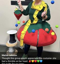 a woman in a costume made to look like a strawberry with measuring tape on it