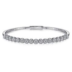 The perfect addition to your ring stacking can be found in this Demure collection bangle that is a chic showcase of modest glamor. Its delicate foundation is made of a delicate base of 14K white gold. Halfway towards the bangle's centerpiece is a extravagant row of round 1.93 ct diamond stations. Giving off an illuminating sparkle, this bangle is versatile enough to wear solo or combine with an assortment of your favorite stackable bracelets. Cheap White Bangle Jewelry, Elegant Stackable Diamond Bangle Bracelet, Stackable Diamond Bangle In White Gold, Wedding Stackable Diamond Tennis Bracelet, Elegant Diamond White Stackable Bracelets, Elegant Stackable Diamond Bracelet For Anniversary, Wedding Diamond Stackable Tennis Bracelet, Timeless Stackable White Gold Bangle, Elegant Stackable Diamond Bracelet For Wedding