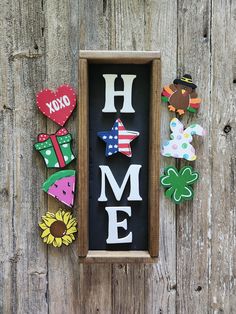 some magnets are hanging on the side of a wooden wall with a sign that says home