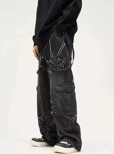 Make a bold statement with our Spider Web Cargo Jeans. These unique black denim pants feature an eye-catching spider web design embroidered in contrasting white thread. The edgy gothic aesthetic is enhanced by strategically placed studs and distressed details. With a relaxed fit and practical cargo pockets, these jeans combine style with functionality. Perfect for those who love alternative fashion, they're ideal for concerts, festivals, or creating a standout street-style look. Black Denim Pants, Strap Pants, Jean Large, Adventure Style, Style Cargo, Retro Mode, Patchwork Jeans, Jeans Y2k, Loose Jeans