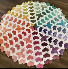 four different colors of hexagonal tiles arranged on the floor with dots in them