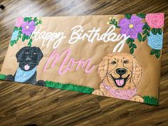 a brown paper bag with two dogs on it and the words happy birthday mom written in white