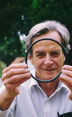 an older man holding a magnifying glass in front of his face while looking through it