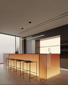 a modern kitchen with an island counter and bar stools in the center, along with floor to ceiling windows