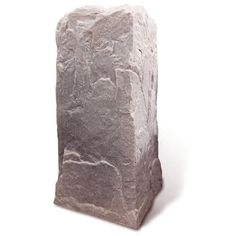 a large stone block sitting on top of a white surface