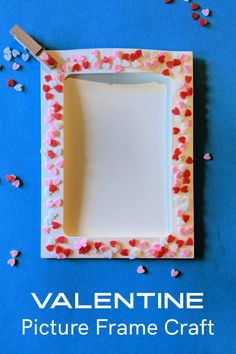 valentine's frame craft made out of paper and colored confetti on a blue background