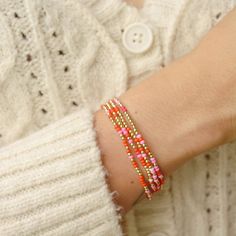 a close up of a person's arm wearing a bracelet with beads on it