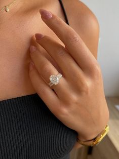 a woman's hand with a diamond ring on it