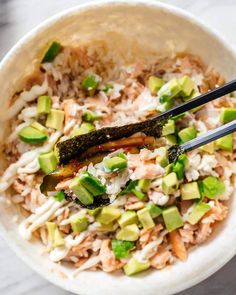 a white bowl filled with rice and vegetables