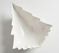 a white ceramic dish on a white surface