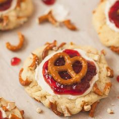 some cookies with jelly and pretzels on them