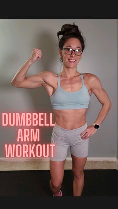 a woman posing for the camera with her arms up and hands behind her head, in front of a neon sign that says dumbbell arm workout