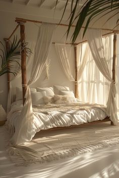 a bed with white sheets and curtains in a room next to a potted plant