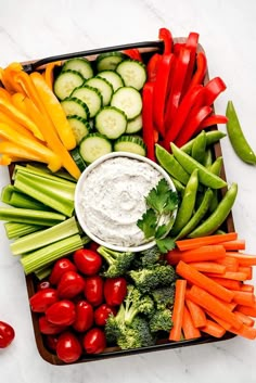 a platter filled with veggies and dip