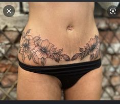 a woman's stomach with flowers on it