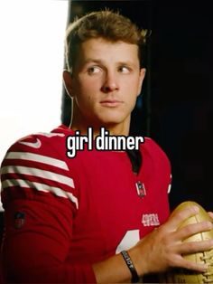 a man in a red uniform holding a football