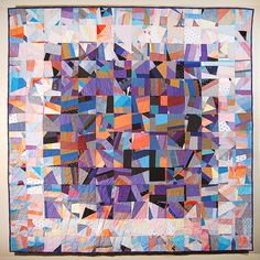 a colorful quilt hanging on the wall