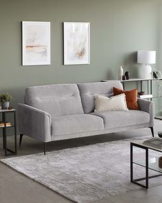 a living room scene with focus on the couch and coffee table in the foreground