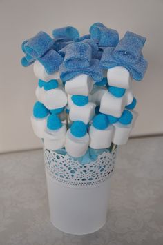 a vase filled with blue and white marshmallows