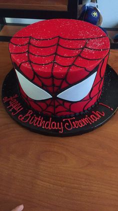 a spiderman birthday cake on a table