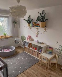 a child's playroom with toys, bookshelves and potted plants