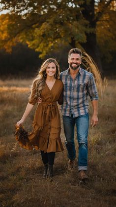 a man and woman are walking through the grass