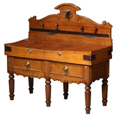 an old wooden desk with drawers on the bottom and one drawer at the top that is open