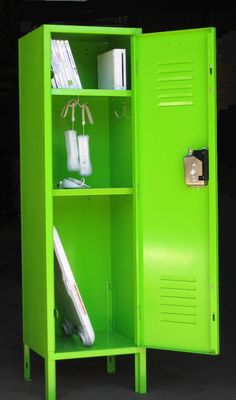 a green metal locker with books and other items in it's storage compartment,