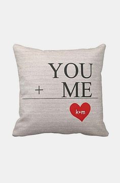 a pillow that says you and me with a heart in the middle, on a white background