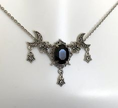 This is a new handmade necklace. It is made with antiqued silver plated filigrees, accented with a high quality JET BLACK glass rhinestone. Decorated portion is 2 1/2" wide and 1 3/4" tall in the center. Necklace is adjustable 15-18" with a lobster clasp and chain extender. If you would like a different length, please send us a message. Gothic Silver Crescent Necklace, Gothic Crescent Silver Necklace, Black Engraved Necklace For Halloween, Black Engraved Necklace For Wedding, Gothic Engraved Adjustable Necklace, Adjustable Oxidized Gothic Necklace, Adjustable Gothic Antique Silver Necklace, Adjustable Gothic Engraved Necklace, Adjustable Engraved Gothic Necklace