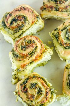 rolls with spinach and cheese are on a plate