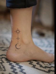 a woman's foot with a small sun and moon tattoo on the side of her ankle