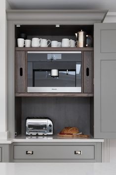 a microwave oven sitting on top of a wooden cabinet