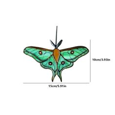 a green butterfly hanging from the side of a white wall with measurements for it's wings