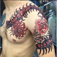 a close up of a man's chest and arm with flowers painted on it