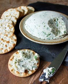 cheese and crackers on a table with a knife