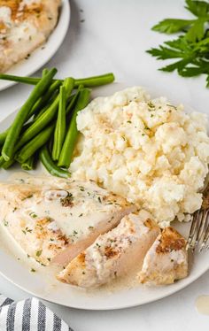 two plates with chicken, mashed potatoes and green beans