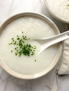 two bowls filled with soup and garnished with chives