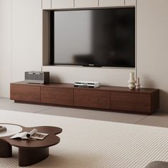 a large flat screen tv mounted to the side of a wall in a living room