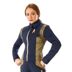 a woman in a star trek uniform is posing for the camera with her hands on her hips